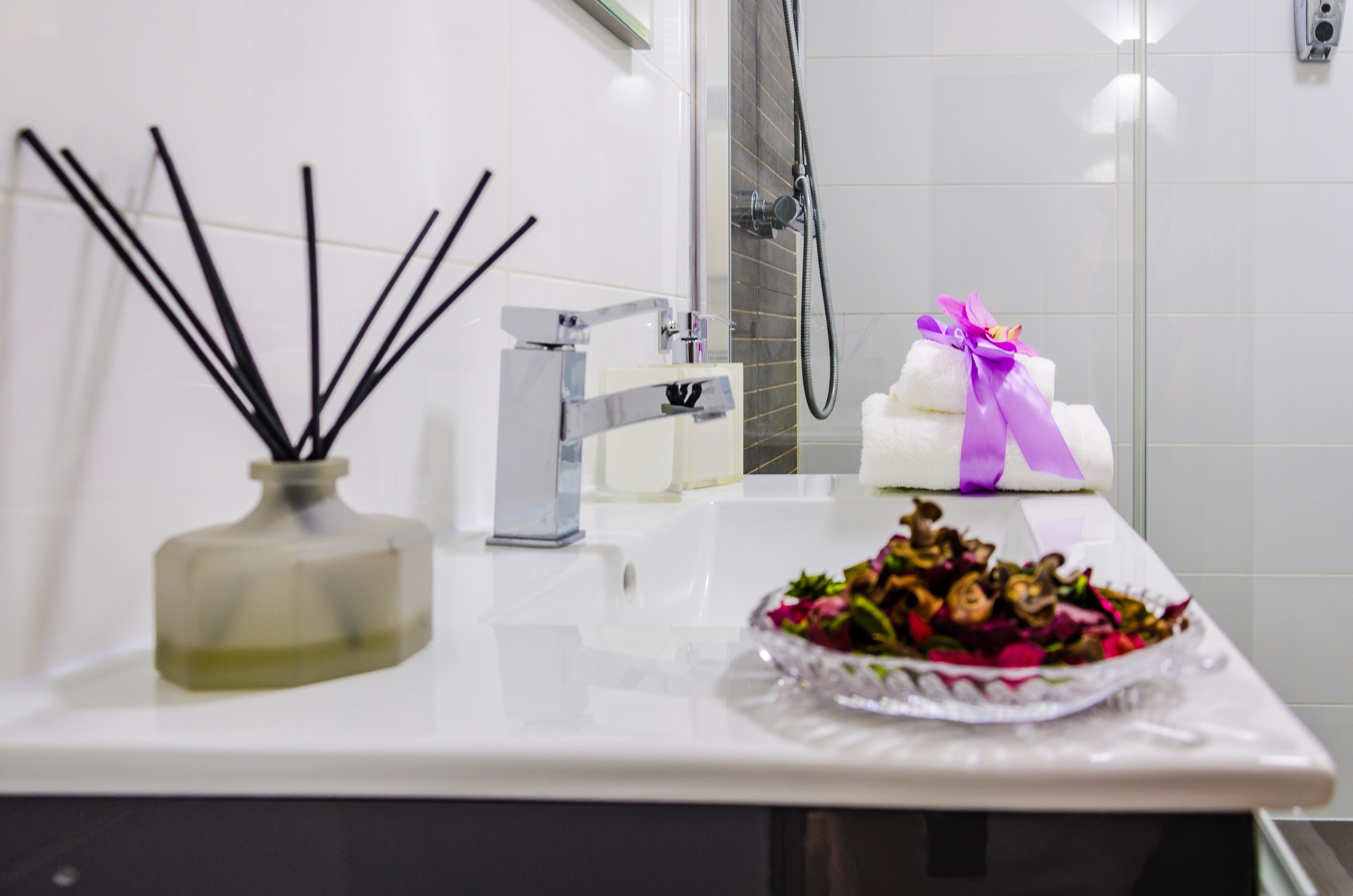 Sink detail with towels and fragrance