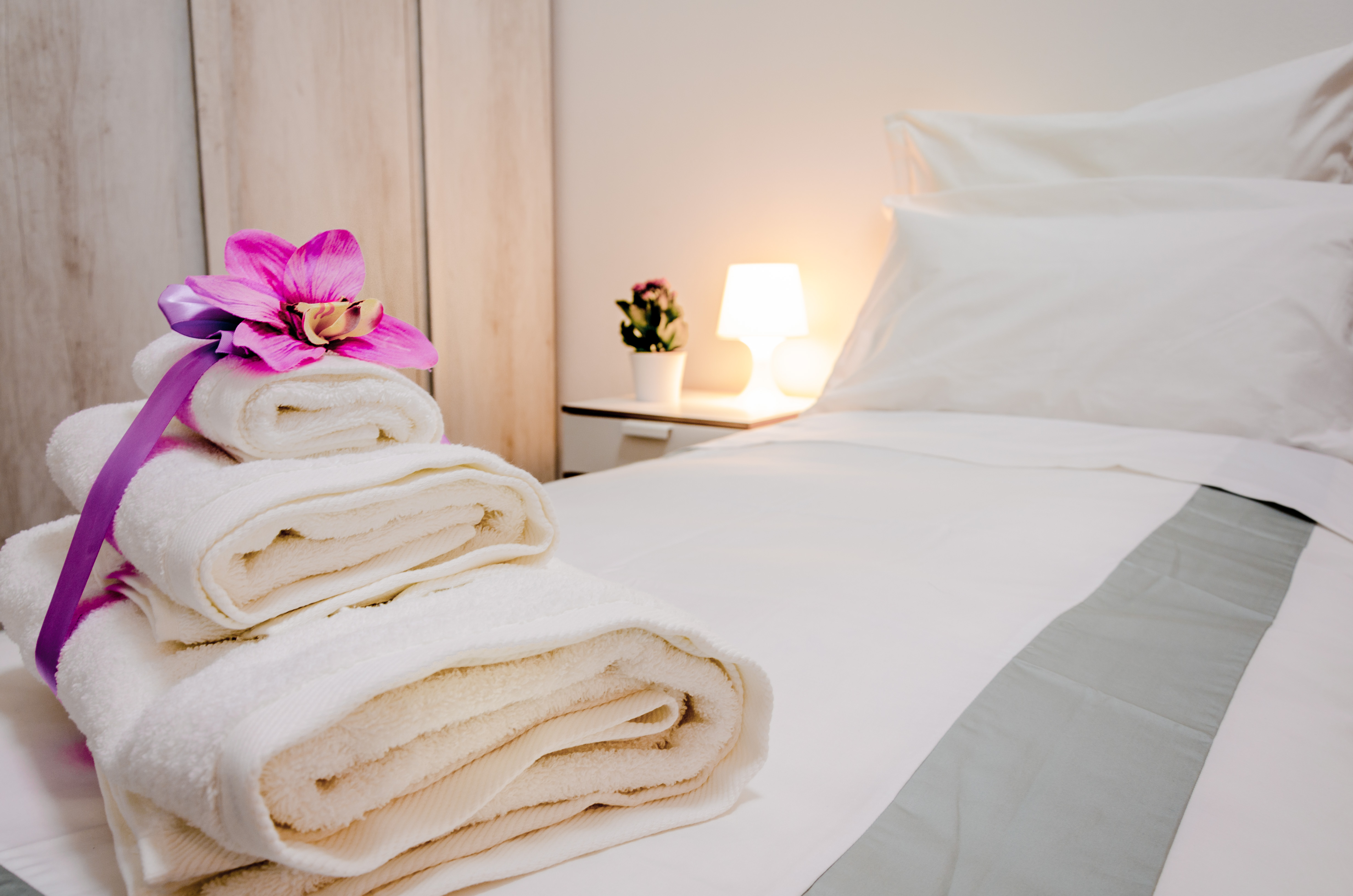 Towels with orchid flower on the bed